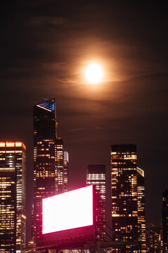 Manhattan cityscape: Full moon in the sky and a glowing screen
