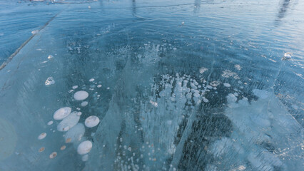 Bubble patterns formed by gases trapped in the freezing water of Lake Baikal in Russia during the winter season