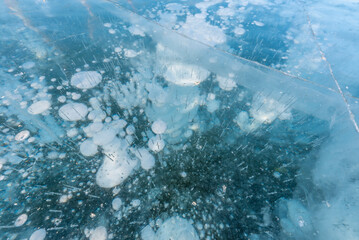 Bubble patterns formed by gases trapped in the freezing water of Lake Baikal in Russia during the winter season