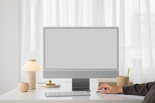 Mockup of a modern gray computer with white screen in a stylish office