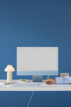 Mockup modern blue computer with white screen in a stylish office