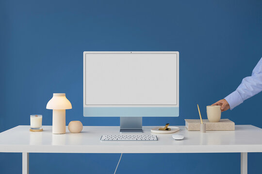 Mockup modern blue computer with white screen in a stylish office