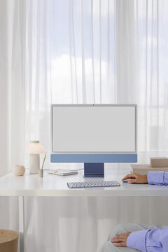 Mockup of a modern blue computer with white screen in a stylish office
