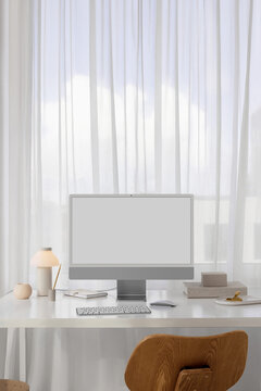 Mockup of a modern computer with white screen in a stylish office