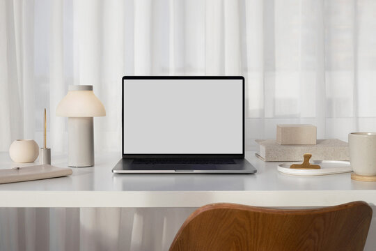 Mockup modern laptop with white screen in a stylish office