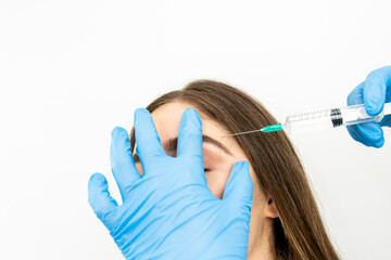 Photo of beautiful woman getting mesotherapy treatment in face by specialist in gloves in beauty...