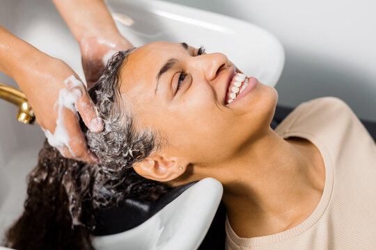 Haircare Expert Washing Hair in Salon - Powered by Adobe