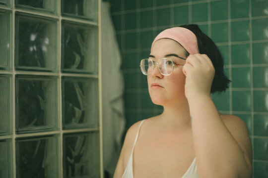 Putting makeup on her brows