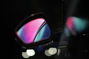 Close u on a car rearview mirror, boreal aurora is visible inside the glass. - 753959445