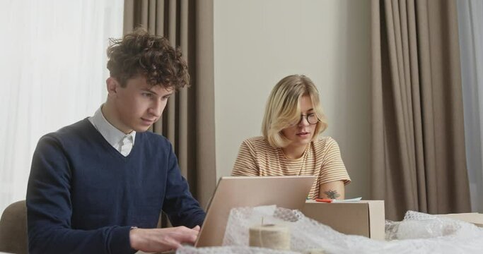 Concentrated Young Team Collaborating on Online Business in Home Office
