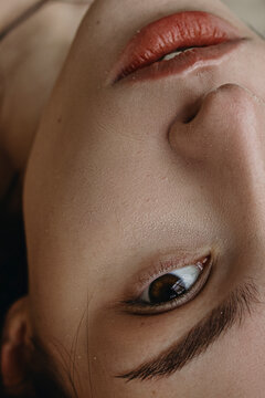 Close Up woman's portrait with brown eyes and red lips