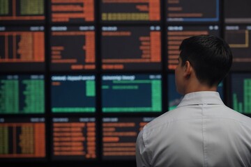 Young man checking stock market and analyzing stock market trends. Financial and Investment concept