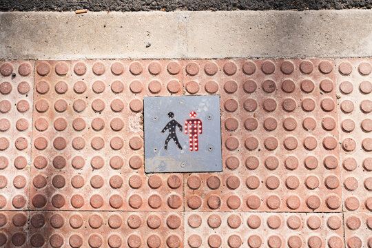 Pedestrian crossing sign on sidewalk.