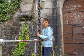 boy at one of the doors of San Felipe Castle in Ferrol, Spain