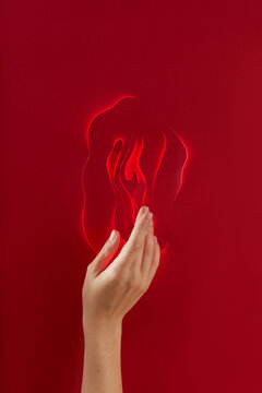 Close up of female hand touching paper made illuminated vagina