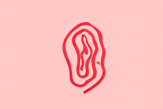 External female genitalia with piercing made of red cut paper