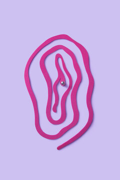 Curved cut paper shaped in female vagina with piercing on clitoris