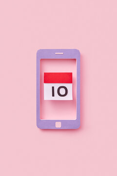 Paper made smartphone showing calendar of female menstrual cycle