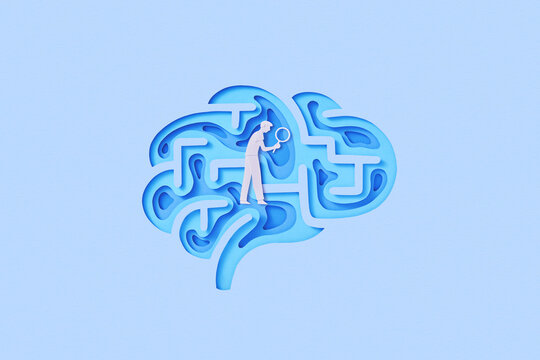 Paper man with loupe walking inside maze in shape of brain