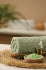 Poster Spa composition. Rolled towel, cosmetic product, sea salt and twig on table indoors. Space for text © New Africa