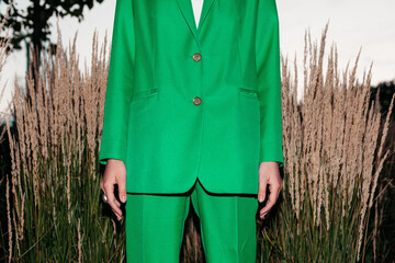 Crop stylish woman standing in field with dry grass