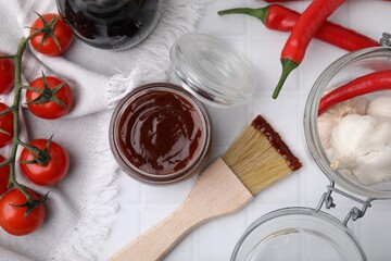 Marinade in jar, ingredients and basting brush on white tiled table, flat lay