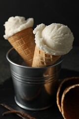 Ice cream scoops in wafer cones on table, closeup