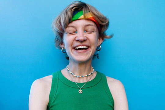Cheerful queer woman with glitter makeup on face