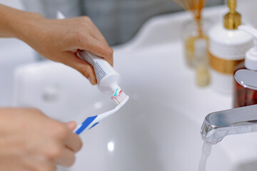 girl hands with toothbrush and toothpaste