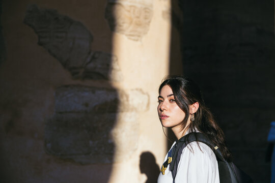 woman with a backpack illuminated by the sunlight in Egypt