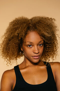 Woman with curly hair in studio