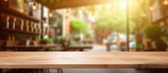A wooden table stands empty in the foreground, with a blurred coffee shop background creating an abstract backdrop. The simple design allows for easy display and montage of products.