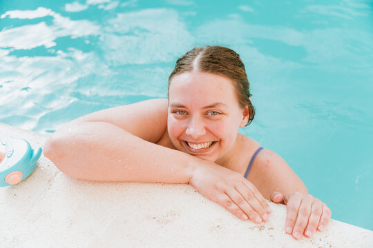 Smiling plus-sized model in the pool
