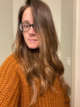 Woman showing off her long, brown hair. 