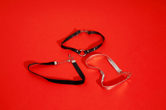 Leather choker jewellery with metallic details & red colour background