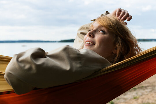 A woman is lying in a hammock