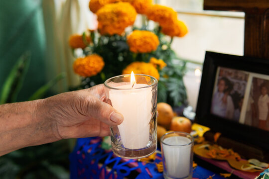 Hand of a person holding a candle