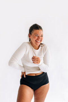Woman Standing in Studio and Laughing