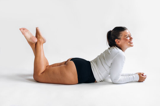 Happy woman lying in studio