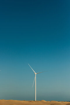Wind turbine on a blue sky at dusk
