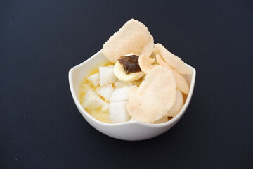 lontong sayur- Compressed rice cake served with curry coconut milk sauce and vegetables and boiled egg