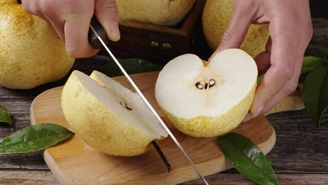 fresh Asian pear fruit and half sliced on wooden table.