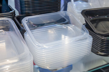 Stacks of plastic food trays for packaging and transporting takeaway food, or for packaging ready...