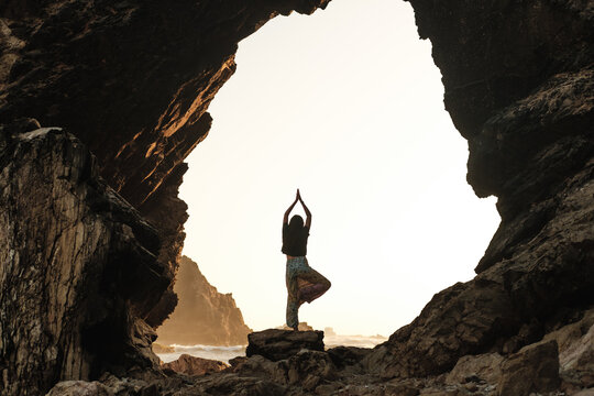 Silhouette of woman doing yoga outdoors
