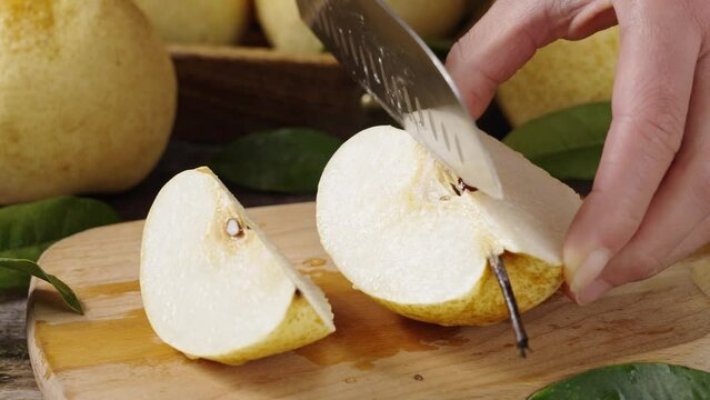 fresh Asian pear fruit and half sliced on wooden table.
