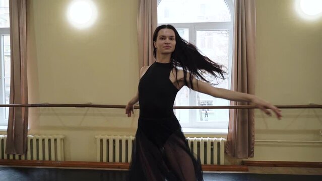The prima ballerina performs circular movements in the old ballet hall