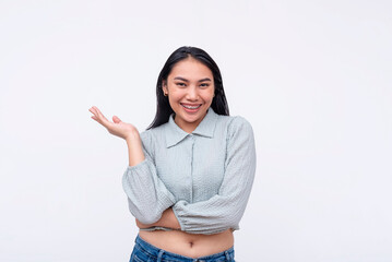 Cheerful young Asian woman with flair with an open hand gesture on a white background, expressing...