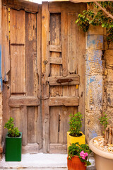 Colourful plant containers and old wooden doors,