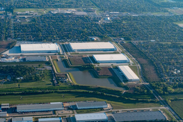 Aerial view of warehouses, suburban homes and a middle school in Dyersdale, Texas