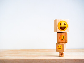 Customer service evaluation, marketing feedback, ratings, satisfaction survey, mental health and psychology concept. Wooden block stack with cute emoticon various emotions face on white background.